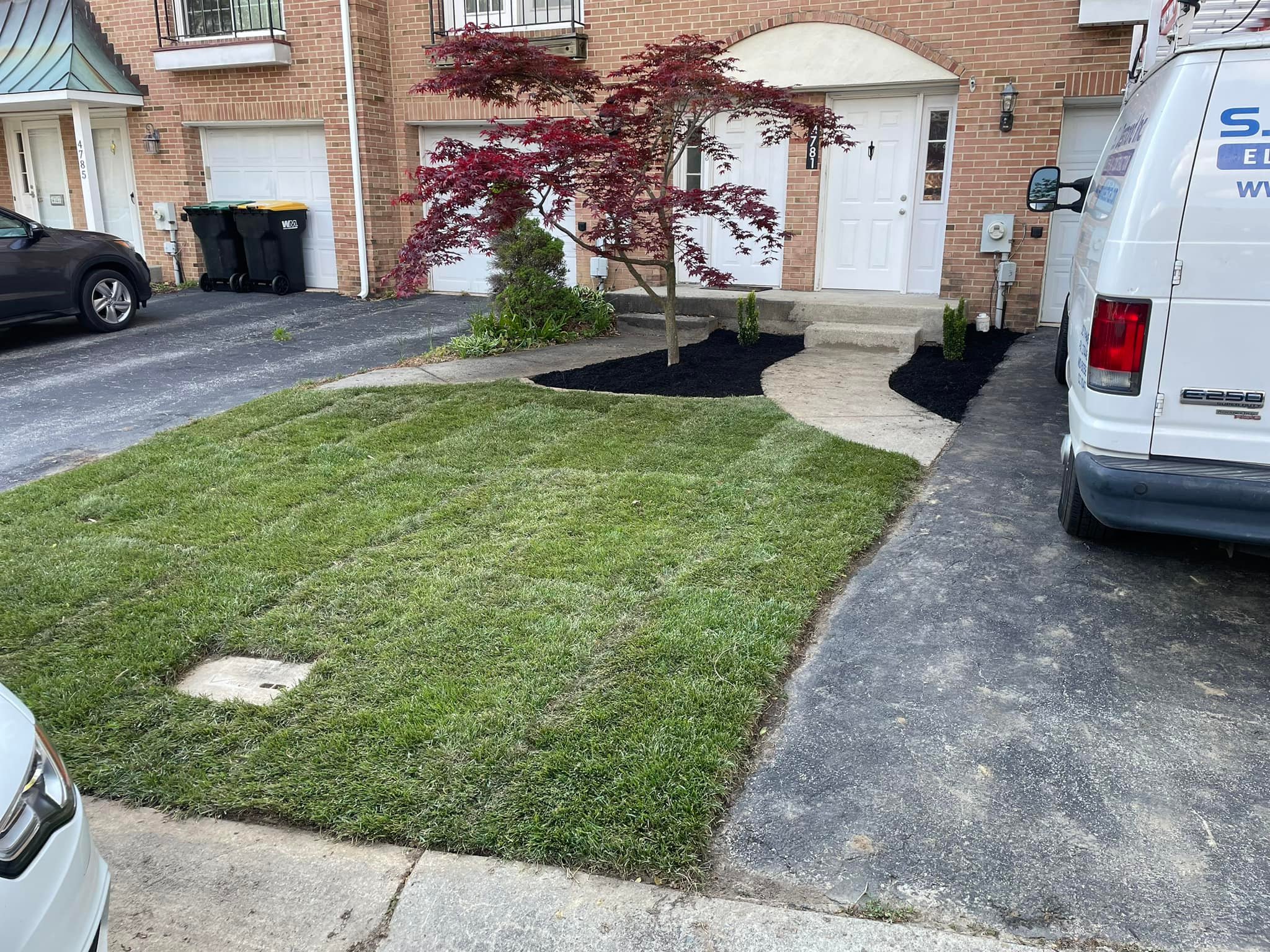 Freshly landscaped home with manicured lawn